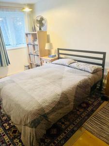 a bedroom with a bed and a window at One Bed Flat by Colindale Tube station in Colindale