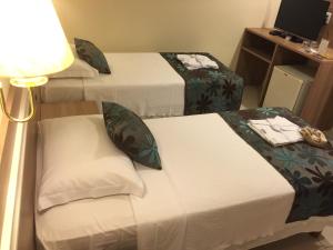 Katil atau katil-katil dalam bilik di Palace Hotel Campos dos Goytacazes