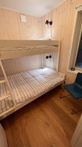 a room with two bunk beds and a chair at Perfect winterhouse in Sälen in Sälen