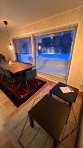 a living room with a table and a large window at Perfect winterhouse in Sälen in Sälen