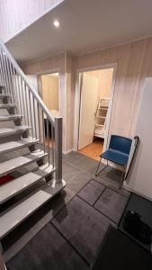 a room with a staircase and a blue chair at Perfect winterhouse in Sälen in Sälen