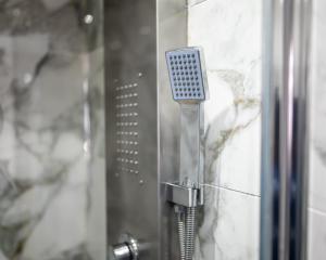 a shower with a shower head in a bathroom at Kunda House Rookery in Birmingham