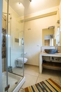een badkamer met een douche, een wastafel en een toilet bij Casadada in Santo Stefano di Camastra