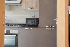 a kitchen with stainless steel appliances and a microwave at YourPlace Rabat - Royal Residence in Rabat
