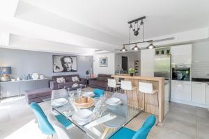 a kitchen and living room with a glass table and chairs at Elia in Roquebrune-Cap-Martin