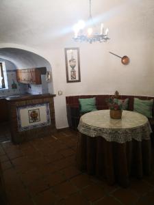 a dining room with a table and a fireplace at Cuevas del Torreón -- Nueva Dirección in Castilléjar