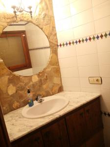 a bathroom with a sink and a mirror at Cuevas del Torreón -- Nueva Dirección in Castilléjar