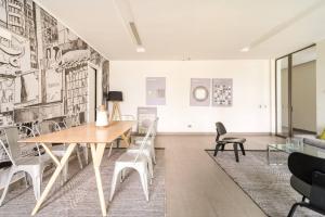 a dining room with a table and chairs at Exclusive Apartment In San Damian, Vitacura in Santiago