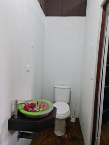 a bathroom with a toilet and a bowl of fruit at Cabañas MOHES ballena in Uvita