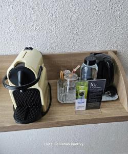 a toaster sitting on top of a wooden shelf at Hôtel Le Rohan Charme et Caractère in Pontivy
