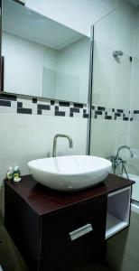 a bathroom with a white sink and a mirror at KABACHI STACK in Lagos
