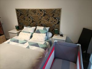 a bedroom with a bed and two night stands at Comme à la maison in Gannat