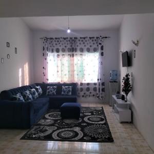 a living room with a blue couch and a window at Aurelia Nelly in Ukunda