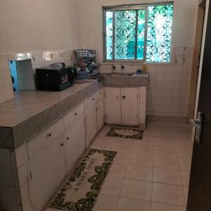 a kitchen with a sink and a window at Aurelia Nelly in Ukunda