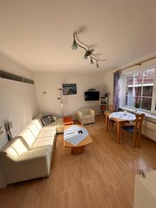 a living room with a couch and a table at Hotel-Pension Haus Hubertus in Borkum