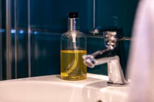 a bottle of oil sitting on top of a sink at Captains Lookout (Studio apartment) in Brecon