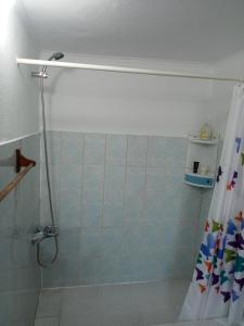 a bathroom with a shower with a shower curtain at O Anexo in Angra do Heroísmo +42 photos