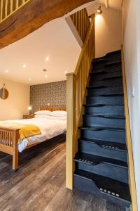 a bedroom with a bed and a staircase at Captains Lookout (Studio apartment) in Brecon