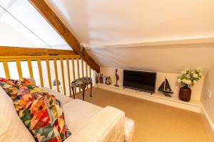 a living room with a couch and a tv at Captains Lookout (Studio apartment) in Brecon