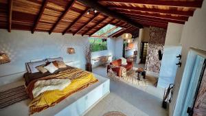 una camera da letto con un letto e un soggiorno di Cabana Rinoceronte a São Bento do Sapucaí