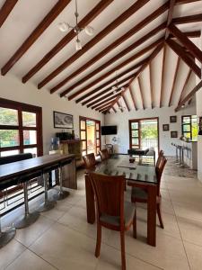 a dining room with a table and a piano at Finca del Bosque in Montenegro