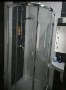 a glass shower in a bathroom with a sink at Luxury Apartment close to seafront in Sliema