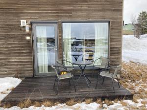 a patio with a table and chairs on a deck at Kirkenes Interlake in Kirkenes