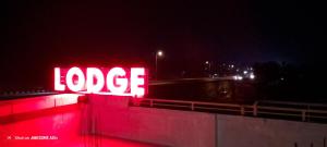 a neon love sign on a wall at night at Sky Residency Lodge in Trichūr