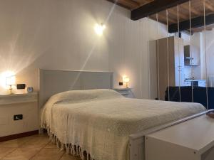 a bedroom with a bed in a room with lights at Teatro Inn - Timeless Charm in Correggio