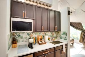 a kitchen with brown cabinets and a sink at Unique Escapes - Nature Lovers Geodome in Monticello