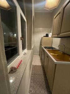 a small kitchen with a sink and a stove at Appartamento Borgosesia Cuore Matto in Borgosesia