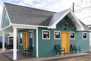 a green tiny house with a bike on the roof at Tour de Fruita & EV charge point in Fruita