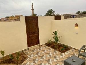 a door on the side of a building with a patio at Charming Garden near Beach+bike in Dahab