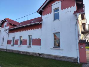 a white and red house with a red roof at Apartmán Ptice in Ptice