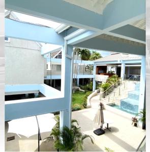 a view from the balcony of a house with a swimming pool at Oceanfront Condo w/ FREE Parking + High Speed Wifi in Negril