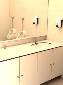 a bathroom with two urinals and a sink at HI Ponte de Lima - Pousada de Juventude in Ponte de Lima