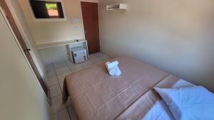 a small bedroom with a bed with a box on it at Pousada Manaíra in João Pessoa +68 photos