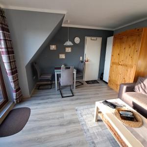 ein Wohnzimmer mit einem Sofa und einem Tisch in der Unterkunft Apartment Boje in Büsum