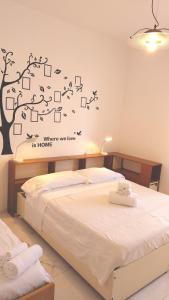 a bedroom with a bed with a tree on the wall at Casa Patrizia in Monterosso al Mare