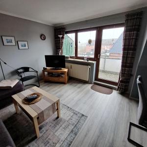 a living room with a couch and a table at Apartment Boje in Büsum