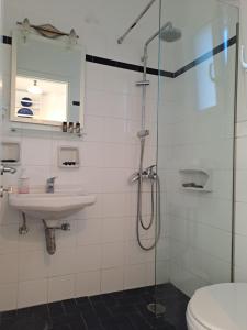 a bathroom with a shower and a sink and a toilet at Agrilia Apartments & Studios in Vathi