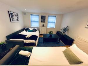 a living room with a bed and a couch at Gorgeous one bed room flat in central London in London