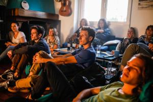 a group of people sitting in a room at Gijon Surf Hostel in Gijón