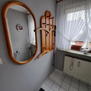 a bathroom with a mirror on the wall at Apartment Boje in Büsum