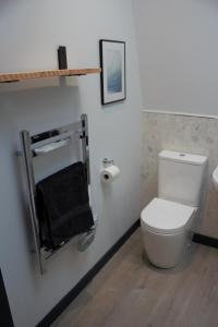 a bathroom with a white toilet and a towel rack at Tigh Na Beithe in North Ballachulish
