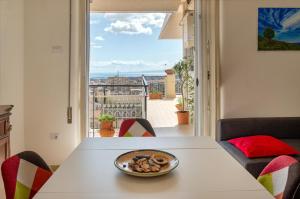a bowl of food on a table in front of a window at Top Floor Aparthotel Bentivoglio in Catania