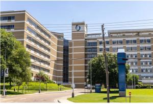 a large building with a clock on the side of it at Fondren Summer Getaway 5 Minutes to Major Hospitals in Jackson
