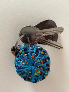 einer mit einer Schlüsselkette verbundenen Garnkugel in der Unterkunft Les Amazones Rouges Chambre Bleue in Ouidah