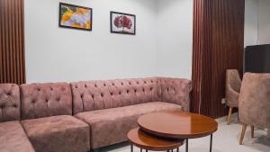 a living room with a couch and a table at Cedarwood Apartments in Abuja