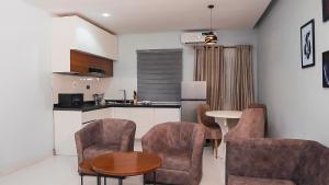 a kitchen and dining room with a table and chairs at Cedarwood Apartments in Abuja